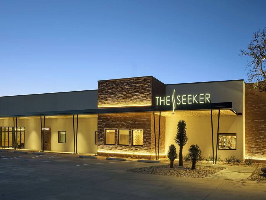 Un bâtiment moderne, sur lequel on peut lire, la nuit, l’inscription « THE SEEKER ».