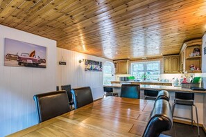 Enjoy meals in this dining area with a long table and comfortable seating for all.