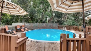 A wooden deck with a pool, surrounded by a wooden fence and covered by striped umbrellas. - Refresh at Rivermist 2 Units with Pool (Savannah)