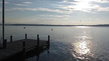 A calm lake with a wooden dock extending into the water.