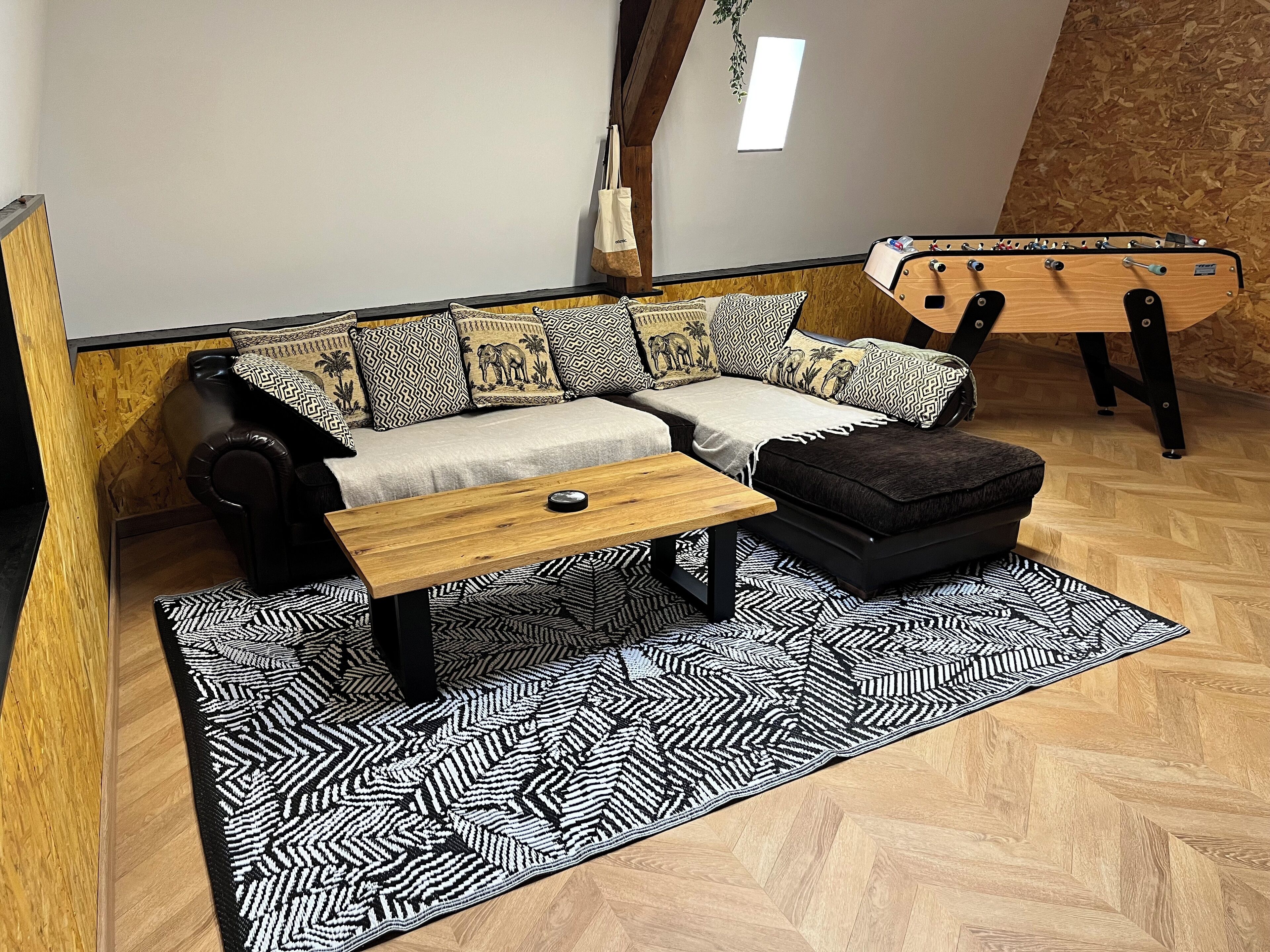 A cozy living room with a sofa set, a coffee table, and a futon.