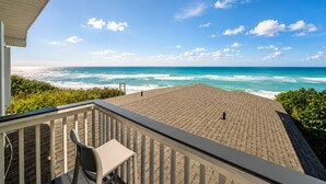 A balcony with a view of the ocean, a chair, and a railing. - Melbourne Beach Oceanfront Apartment Unit #2 - Ocean Views (Melbourne Beach)