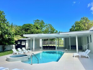 A modern outdoor swimming pool with lounge chairs and a covered patio area. - Unique Top Caribbean Private Retreat (LUQUILLO)
