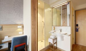 A modern bathroom with a shower, sink, and mirror. - Holiday Inn Express Greater Noida Knowledge Park by IHG (Greater Noida)