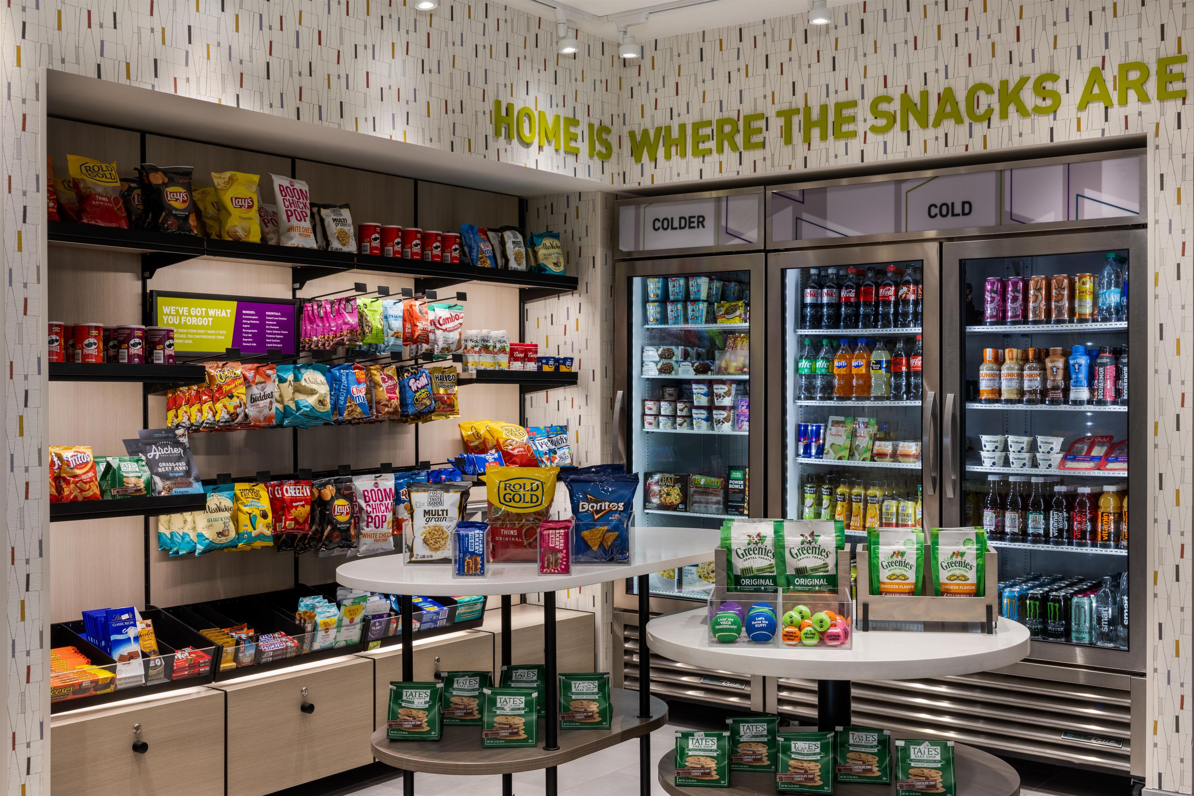 A snack display area with various packaged snacks and beverages, including chips, cookies, and drinks.