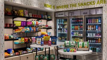 A snack display area with various packaged snacks and beverages, including chips, cookies, and drinks.