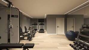 Een moderne sportschool met fitnessapparatuur, een grote trainingsbal en een bank.