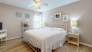 A bedroom with a bed, a nightstand, a desk, and a ceiling fan. - Beach Access Across the Street, Shared Heated Pool (Corpus Christi)