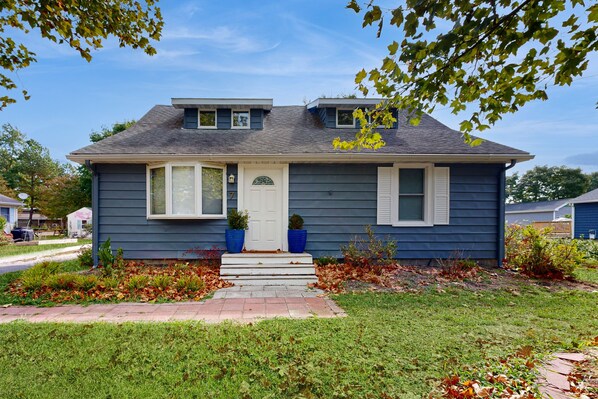 Stroll up to this charming two-story home with a welcoming front porch and beautifully manicured lawn.