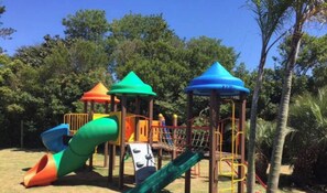 A playground with multiple slides and climbing structures.