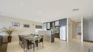 A modern kitchen with dark cabinets, a microwave, and a refrigerator. - The Cove, Port Hughes (Port Hughes)