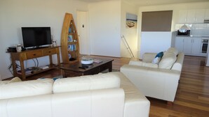 A living room with a sofa, TV, wooden bookshelf, and a coffee table. - Shell Seeker, Moonta Bay (Moonta Bay)