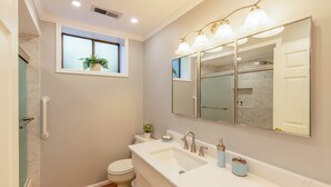 A modern bathroom with a large mirror, two sinks, a toilet, and a shower area. - Secluded Private Suite in Bridle Trails – Near Major Tech & 25 Min to Seattle (Bellevue)