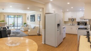 A modern kitchen with white cabinets, a refrigerator, and a microwave. - Secluded Private Suite in Bridle Trails – Near Major Tech & 25 Min to Seattle (Bellevue)