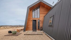 A modern building with a wooden facade and a large window. - Avonside Alpine Estate - Jindabyne (Avonside)