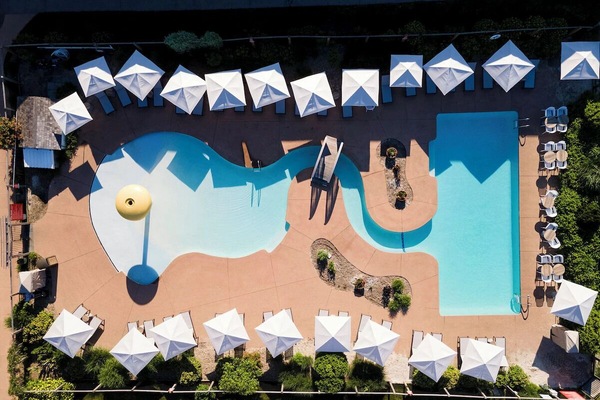 Picture your day poolside with roomy loungers and umbrellas.