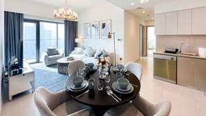 A modern apartment with a dining area, kitchen, and living room. - Stunning Burj View Sky High Luxury 2BR (Dubai)