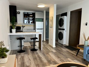Enjoy a compact living space with a kitchenette, stove, and refrigerator, perfect for a home away from home.
