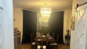 A dining area with a chandelier, wooden table, and chairs. - Welcome to the perfect Oxford getaway for an Ole Miss game.  (Oxford)