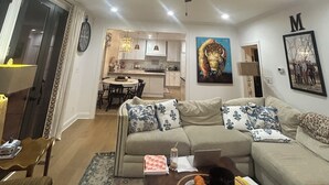 A living room with a sofa, coffee table, and a dining area in the background. - Welcome to the perfect Oxford getaway for an Ole Miss game.  (Oxford)