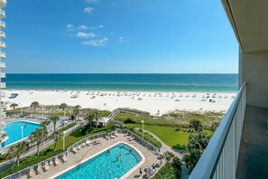 A pool area with a view of the beach and ocean. - BEACHFRONT, TWO POOLS, PRIVATE BALCONY! (Orange Beach)