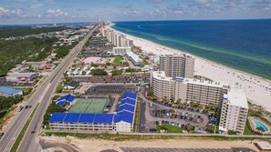 A coastal hotel with multiple floors, a beach view, and a parking lot. - BEACHFRONT, TWO POOLS, PRIVATE BALCONY! (Orange Beach)
