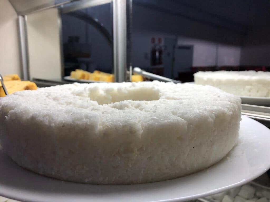 A white cake on a plate.