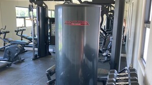 A gym with various exercise equipment including dumbbells, treadmills, and weight machines. - Modern, Cozy, Airy 3-Bedroom Tropical Escape in Oceanpointe, Hanover, Jamaica (Lucea)