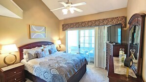 A bedroom with a bed, bedside lamps, a dresser, a mirror, and a ceiling fan. - 3-Bedroom Condo, Penthouse Suite, Remodeled, Golf Course View, Excellent Rates!! (Branson)