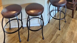 A modern kitchen with a central island, wooden cabinets, and a bar stool seating area. - 3-Bedroom Condo, Penthouse Suite, Remodeled, Golf Course View, Excellent Rates!! (Branson)