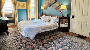 A bedroom with a bed, a nightstand, a fan, and a door. - Jade Room at The Amethyst Inn B&B, jacuzzi, fireplace, antiques and Lancaster   (Adamstown)