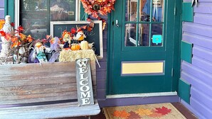 A front porch with a 'Welcome' sign, a bench, a wreath, and a door with a window. - Jade Room at The Amethyst Inn B&B, jacuzzi, fireplace, antiques and Lancaster   (Adamstown)