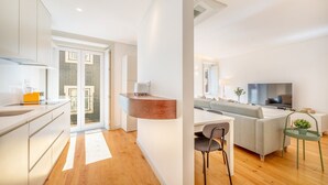Un appartement moderne comprenant une cuisine, un coin repas et un salon.