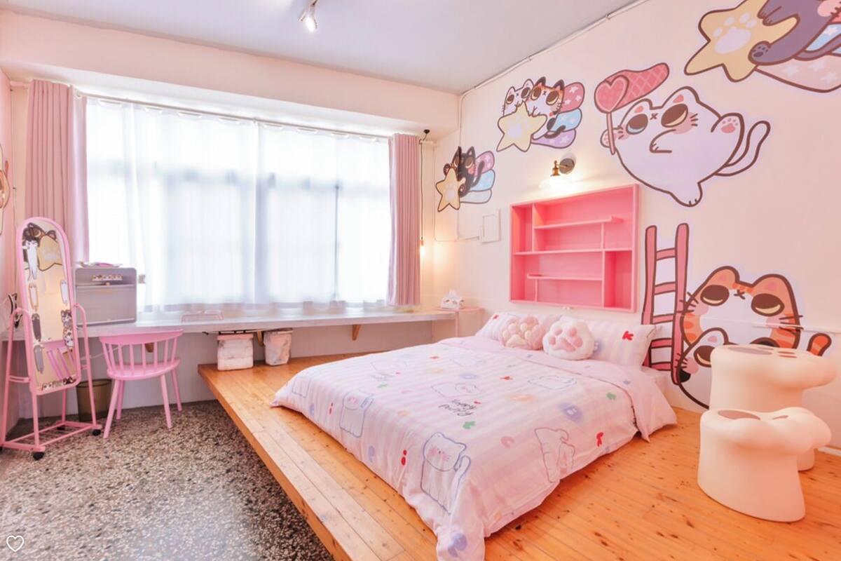 A cozy bedroom with a bed, a desk, and a chair.