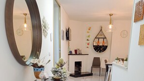 A modern hallway with a marble floor, a large mirror, and a glass-top console table with decorative plants. - La Giulietta (Tortorella)