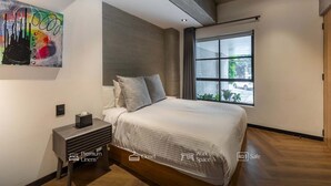 A modern bedroom with a large bed, a nightstand, a window with a view, and a painting on the wall. - Park Condesa | 2BR, Rooftop Spa & Gym (Ciudad de México)