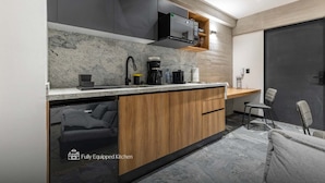 A modern kitchen with a built-in dishwasher, a coffee maker, and a microwave. - Park Condesa | 2BR, Rooftop Spa & Gym (Ciudad de México)