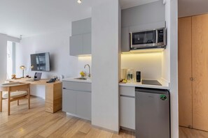 A modern kitchen with a built-in microwave, a dishwasher, and a sink.