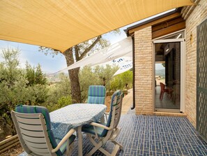 An outdoor patio with a table and chairs, a covered area with a canopy, and a view of the surrounding landscape. - Stunning  villa with hot tub, private pool, WIFI, A/C, patio, pets allowed and panoramic view (Città Sant'angelo)