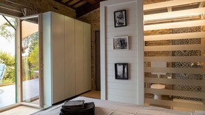 A bedroom with a bed, a wardrobe, a wall with framed pictures, and a view of the outdoors. - Wonderful  villa with WIFI, private pool, A/C, hot tub, patio, pets allowed and panoramic view (Città Sant'angelo)
