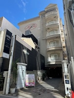 A hotel entrance with a sign indicating it's open.