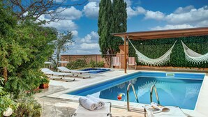 A swimming pool with lounge chairs, a hammock, and a pergola. - Villa Sorrentina With Panoramic Terrace (Massa Lubrense)