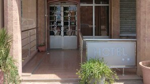 The entrance of Hotel Azaghah with a signboard displaying its name and a welcome sign. - Hotel Azaghar (M'rirt)