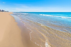 A beach with clear blue water and a sandy shore. - Llam Ntol in Oliva With 3 Bedrooms and 1 Bathrooms (Oliva)