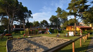 A playground with sandpit, swings, and climbing structures. - Azzurro C2-6 in Bibione (San Michele al Tagliamento)