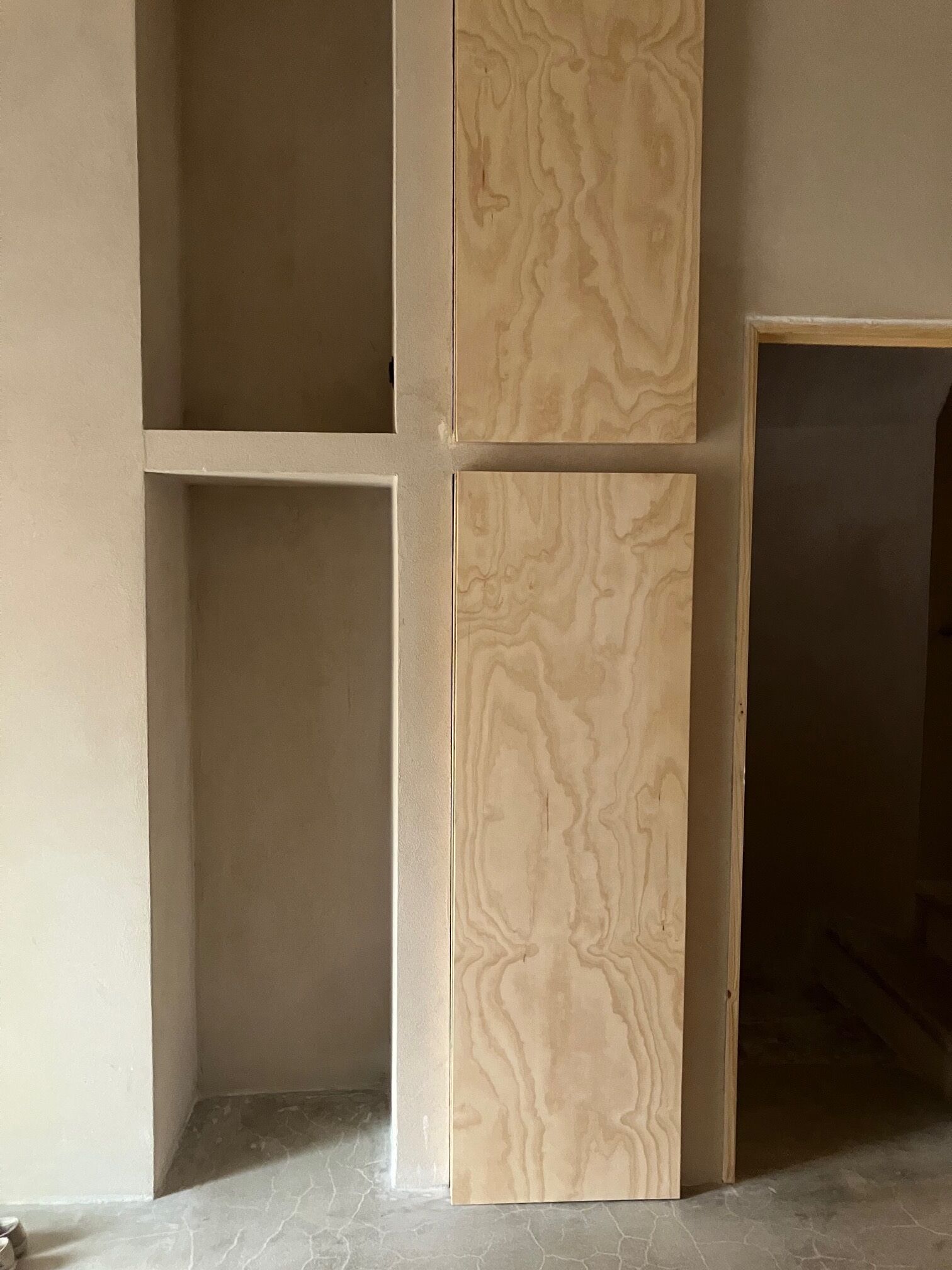 A room with a tiled floor and a partially open door.