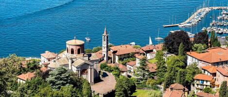 A coastal town with a prominent church, marina, and residential buildings.