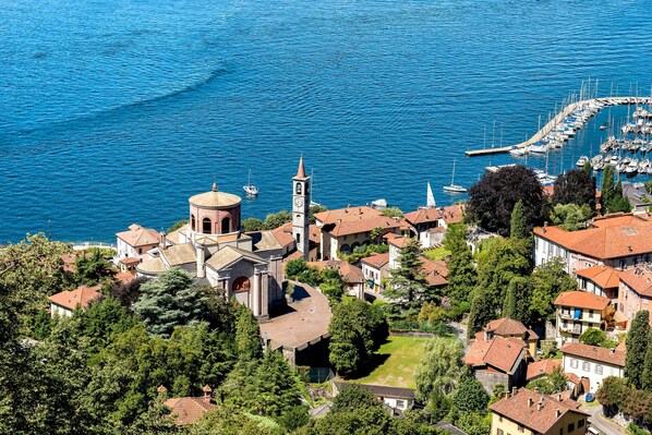 A coastal town with a prominent church, marina, and residential buildings.