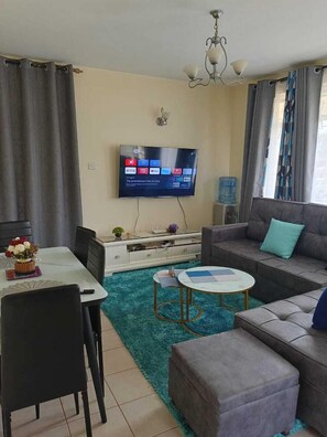 Classic Apartment, Balcony, City View | Living area | 24-inch Smart TV with digital channels - Lux Suites MacDade Apartments (Nairobi)