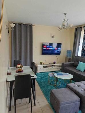 Classic Apartment, Balcony, City View | Living area | 24-inch Smart TV with digital channels - Lux Suites MacDade Apartments (Nairobi)